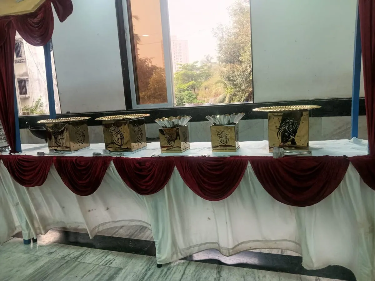 Brass handis on a buffet table beside a window