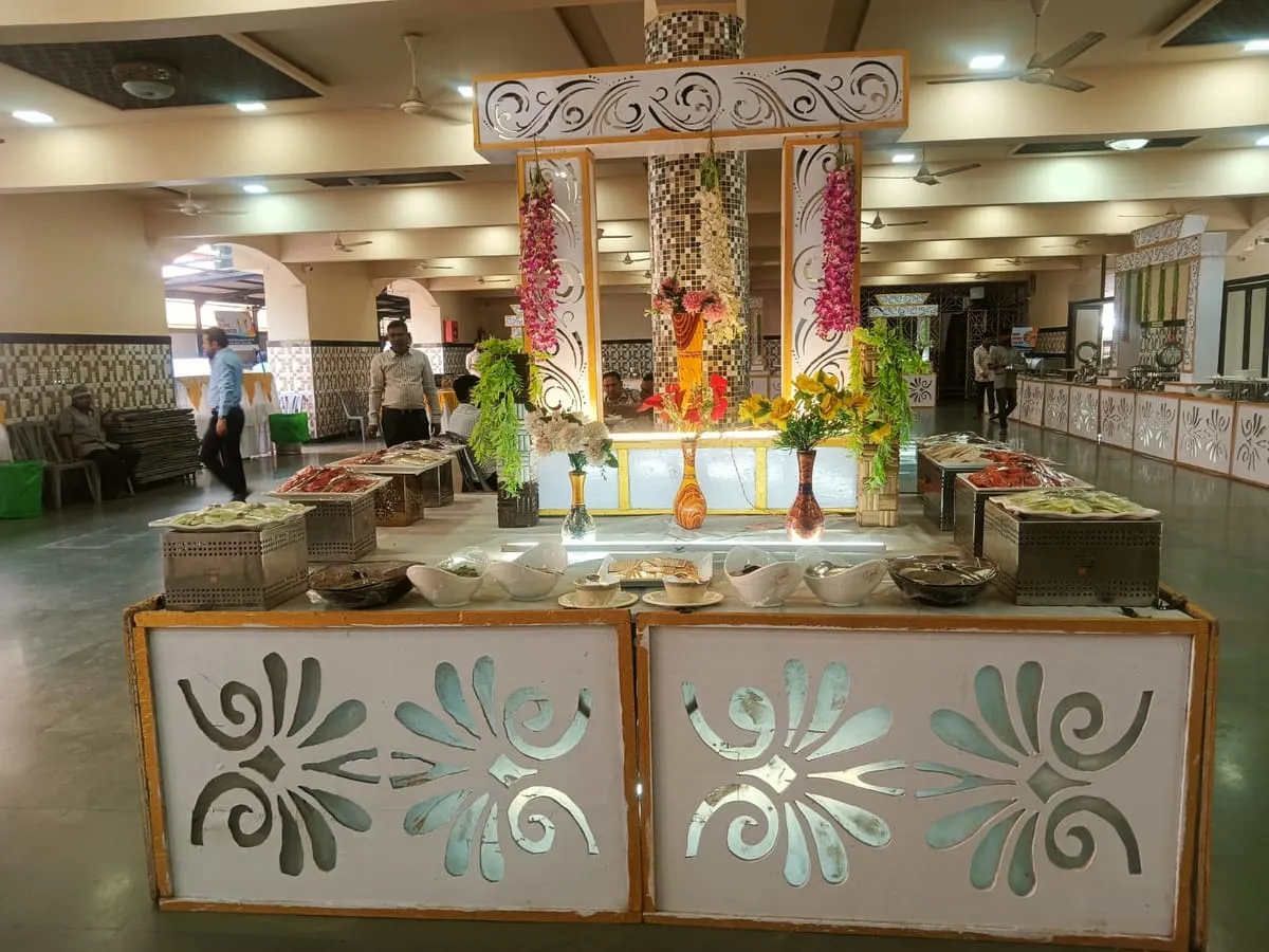 Buffet counter with carved panels and trays of food
