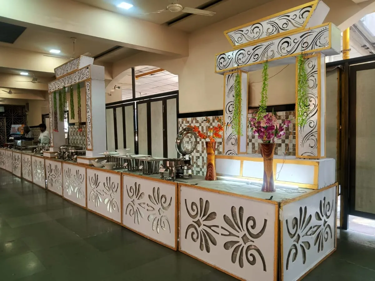 Long buffet line set up under a decorated archway