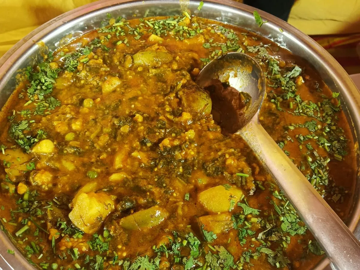 Mixed vegetable curry served in a copper bowl