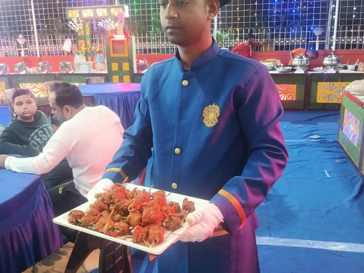Serving staff carrying a tray of starters to guests